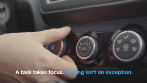 Person adjusting the radio in a car