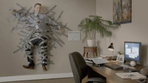man taped to wall