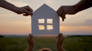 family holding paper house